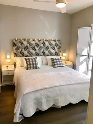 a bedroom with a large white bed with pillows at GATU PREMIUM La Casa del Arco con wifi, aire acc, terraza ,