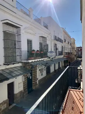 a row of buildings with balconies on a street at GATU PREMIUM La Casa del Arco con wifi, aire acc, terraza ,