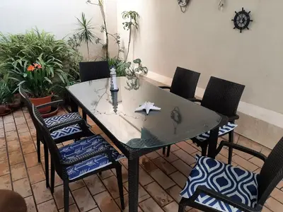 a dining room table with chairs and a starfish on it at Apartment Huerta del Obispo in Cádiz