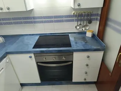 a kitchen with a stove and a blue counter top at Apartment Huerta del Obispo in Cádiz