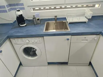 a kitchen with a sink and a washing machine at Apartment Huerta del Obispo in Cádiz