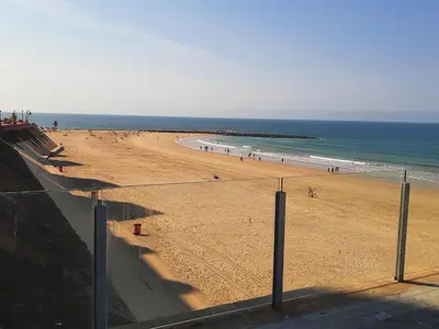 a beach with a group of people on it at Apartment Huerta del Obispo in Cádiz