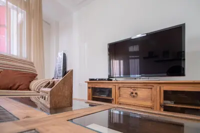 a living room with a large flat screen tv at Apartamento Nuestra Andalucia - Cadiz Centro - parking in Cádiz