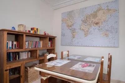 a room with a table and a map on the wall at Apartamento Nuestra Andalucia - Cadiz Centro - parking in Cádiz