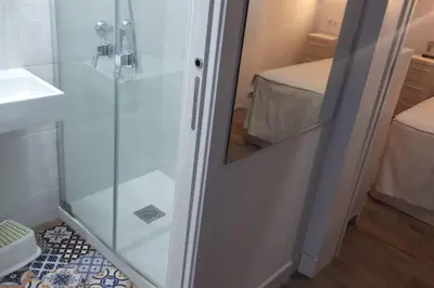 a shower with a glass door in a bathroom at Casa con encanto junto a la playa de La Puntilla in El Puerto de Santa María