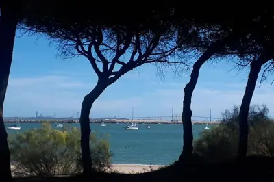 a view of a beach with boats in the water at Casa con encanto junto a la playa de La Puntilla in El Puerto de Santa María