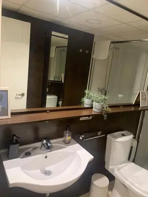 a bathroom with a sink and a toilet and a mirror at Estudio Alameda in Cádiz