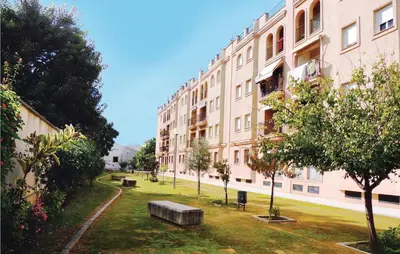 a large building with a park in front of it at Cozy Apartment In Jerez De La Frontera in Jerez de la Frontera
