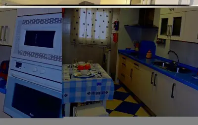 a kitchen with a white stove and a sink at Cozy Apartment In Jerez De La Frontera in Jerez de la Frontera