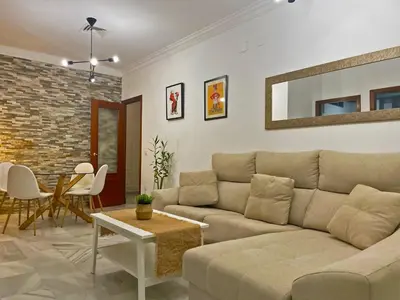 a living room with a couch and a table at Apartamento Armas - Ole Solutions in Jerez de la Frontera
