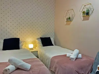 two beds in a room with towels on them at Apartamento Armas - Ole Solutions in Jerez de la Frontera