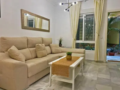 a living room with a couch and a table at Apartamento Armas - Ole Solutions in Jerez de la Frontera