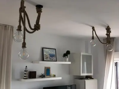 a kitchen with three lights hanging from the ceiling at Terraza Mirador del Coto in Sanlúcar de Barrameda