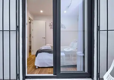 a view of a bedroom through a sliding glass door at Precioso duplex con patio junto a la Catedral in Cádiz