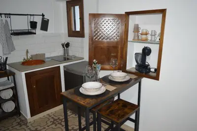 a kitchen with a table with dishes on it at CASA MONTAÑA in Arcos de la Frontera