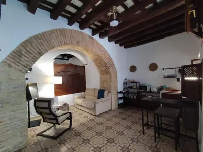 a living room with a couch and a piano at CASA MONTAÑA in Arcos de la Frontera