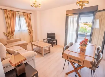 a living room with a couch and a table at SibsSanlucar Manzanilla-Piscina-Terraza-BajoGuia-Playa-Centro in Sanlúcar de Barrameda