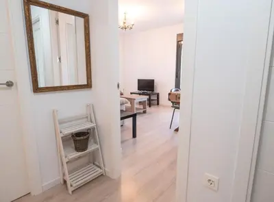 a hallway with a mirror and a living room at SibsSanlucar Manzanilla-Piscina-Terraza-BajoGuia-Playa-Centro in Sanlúcar de Barrameda