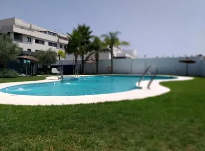 a swimming pool in a yard next to a building at SibsSanlucar Manzanilla-Piscina-Terraza-BajoGuia-Playa-Centro in Sanlúcar de Barrameda