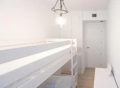 a white room with a large white wall at SibsSanlucar Manzanilla-Piscina-Terraza-BajoGuia-Playa-Centro in Sanlúcar de Barrameda