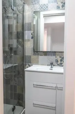 a bathroom with a sink and a shower with a mirror at Brisa Marinera Grupo AC Gestion in Cádiz