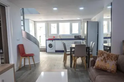 a living room with a couch and a table and chairs at Brisa Marinera Grupo AC Gestion in Cádiz