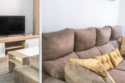 a living room with a brown couch and a table at Brisa Marinera Grupo AC Gestion in Cádiz