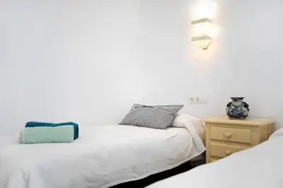 a bedroom with two beds and a night stand at Precioso alojamiento en Cádiz junto al mercado in Cádiz
