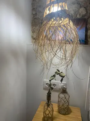 a chandelier hanging over a table with two vases at Pitusa Home in Cádiz