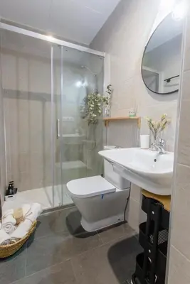 a bathroom with a toilet and a sink and a shower at Pitusa Home in Cádiz