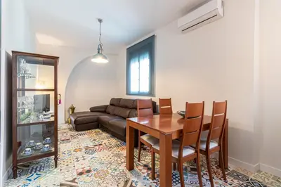 a living room with a table and a couch at Allo Apartments Remedios Centro 2 Habitaciones in Jerez de la Frontera