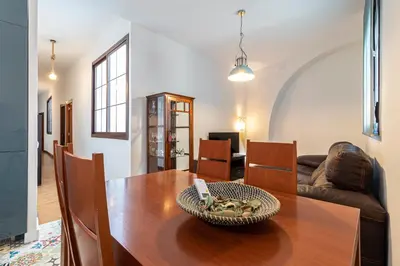 a living room with a wooden table and a couch at Allo Apartments Remedios Centro 2 Habitaciones in Jerez de la Frontera