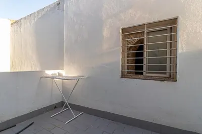 a table in front of a wall with a window at Allo Apartments Remedios Centro 2 Habitaciones in Jerez de la Frontera