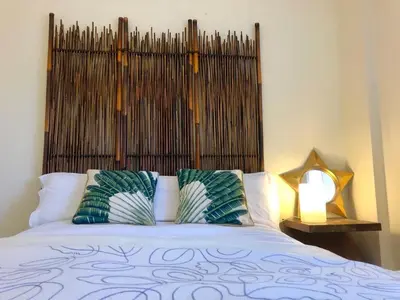 a bed with two pillows on top of it at GATU PREMIUM Atico Sotavento playa, parking, terraza, piscinas, wifi y aire acc , 