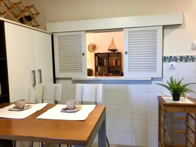 a kitchen with a table with two cups on it at GATU PREMIUM Atico Sotavento playa, parking, terraza, piscinas, wifi y aire acc , 