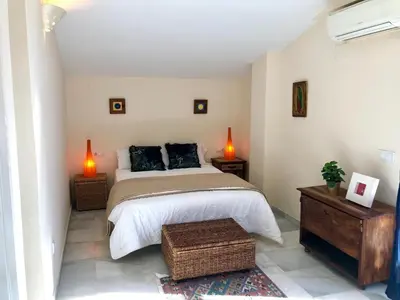 a bedroom with a bed with two lamps and two tables at GATU PREMIUM Atico Sotavento playa, parking, terraza, piscinas, wifi y aire acc , 