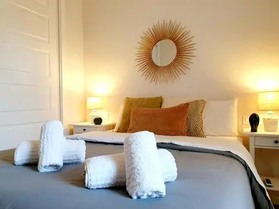 a bedroom with a bed with white towels on it at Sherryflat C/ Arcos in Jerez de la Frontera
