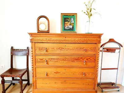 a dresser with a mirror on top of it and a chair at Sherryflat C/ Arcos in Jerez de la Frontera