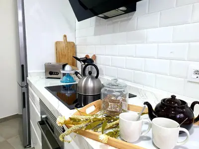 a kitchen counter with cups on a counter top at Sherryflat C/ Arcos in Jerez de la Frontera