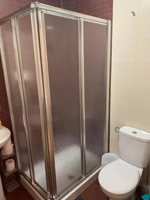 a shower stall in a bathroom with a toilet at Palma 2 sueños in Jerez de la Frontera