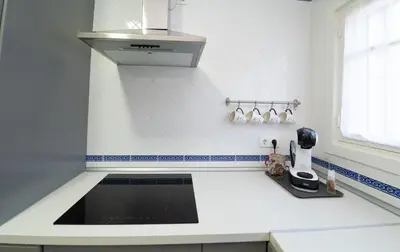 a kitchen with a counter top with a sink at Apartamento Centro Calle Plata in Sanlúcar de Barrameda