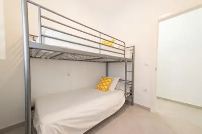 a bedroom with a bunk bed in a room at Apartamento Centro Calle Plata in Sanlúcar de Barrameda