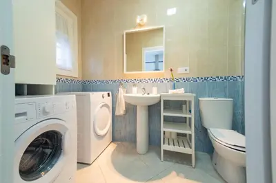 a bathroom with a washing machine and a sink at Apartamento Centro Calle Plata in Sanlúcar de Barrameda