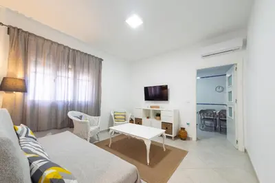 a living room with a couch and a table at Apartamento Centro Calle Plata in Sanlúcar de Barrameda