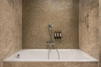 a bath tub with a phone in a bathroom at Áurea Casa Palacio Sagasta by Eurostars Hotel Company in Cádiz