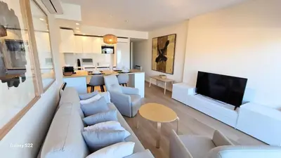 a living room with a couch and a tv at Boutelou playa con vistas al mar in Sanlúcar de Barrameda