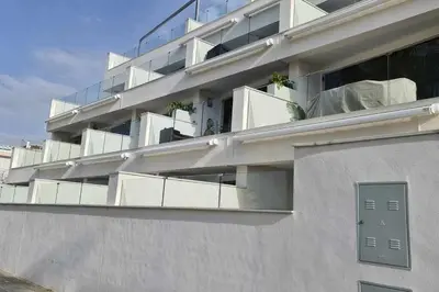a building with balconies on the side of it at Boutelou playa con vistas al mar in Sanlúcar de Barrameda