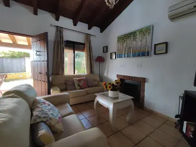 a living room with a couch and a fireplace at Casa Juanse in Conil de la Frontera