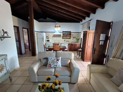 a living room with a couch and a table at Casa Juanse in Conil de la Frontera
