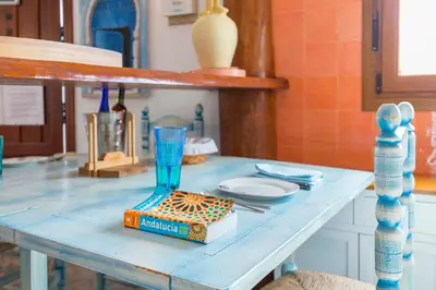 a blue table with a glass on top of it at La Ballena Azul CONIL in Cádiz